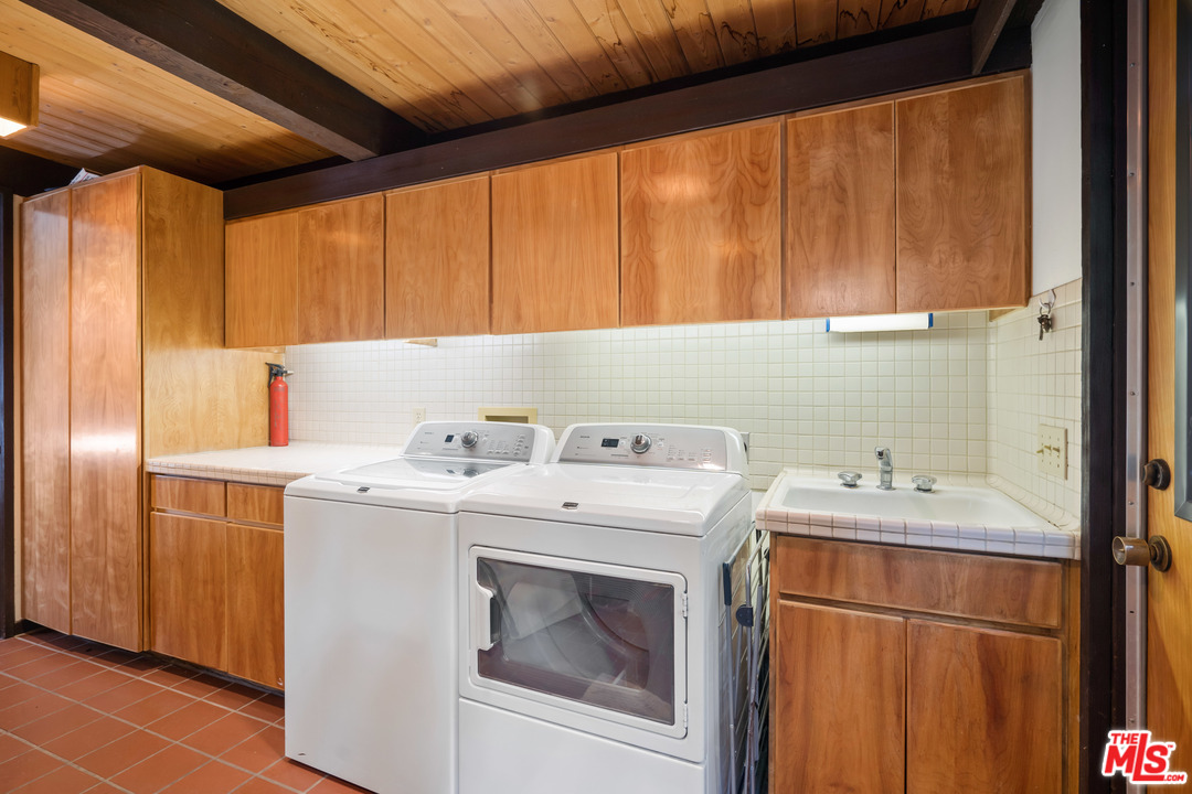 481 Cold Canyon Road Calabasas, CA 91302 - Photo 34 of 44 a utility room with dryer and washer