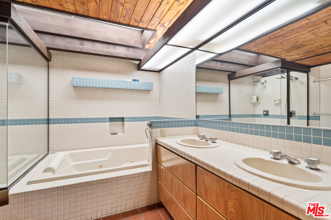 481 Cold Canyon Road Calabasas, CA 91302 - Photo 36 of 44 a bathroom with a tub sink and mirror
