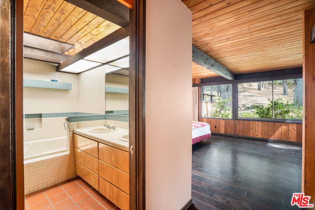 481 Cold Canyon Road Calabasas, CA 91302 - Photo 37 of 44 a view of an empty room with wooden floor and a window