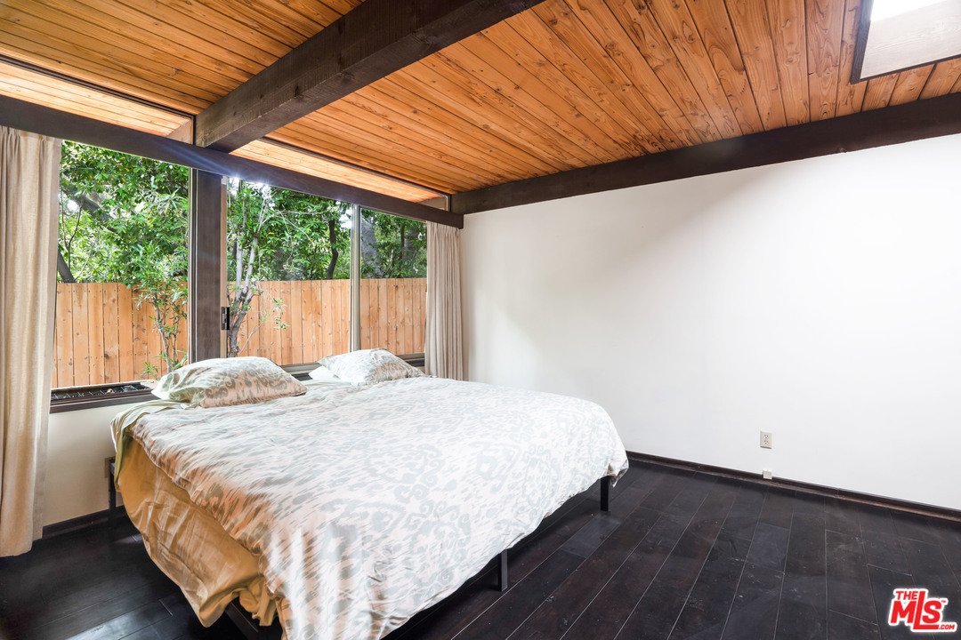 481 Cold Canyon Road Calabasas, CA 91302 - Photo 40 of 44 a bed sitting in a spacious bedroom next to a window