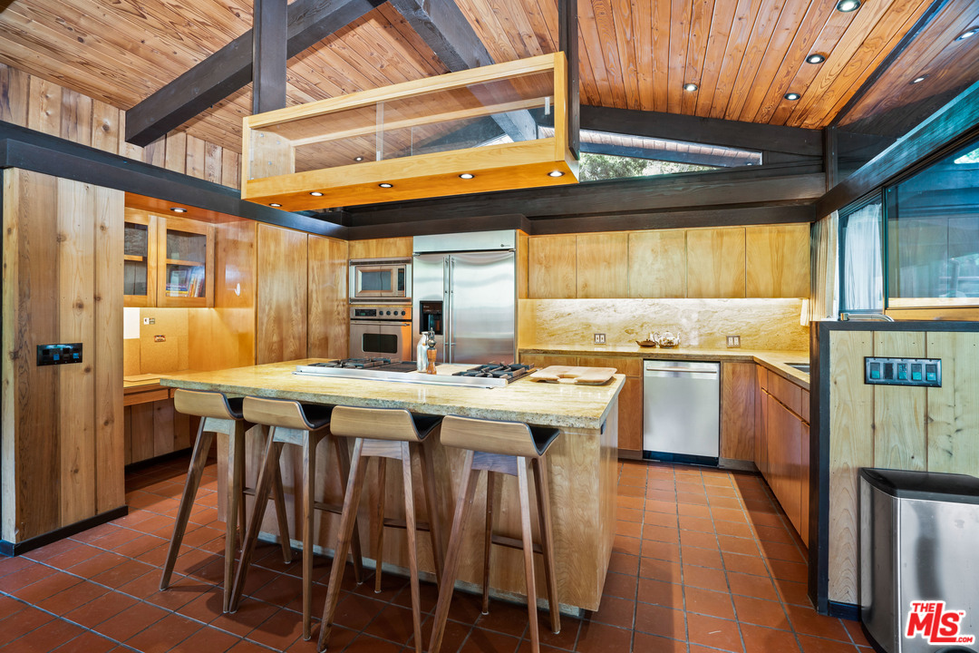 481 Cold Canyon Road Calabasas, CA 91302 - Photo 5 of 44 a kitchen with a stove a refrigerator and wooden floor