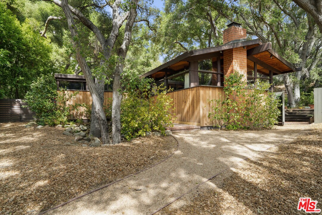 481 Cold Canyon Road Calabasas, CA 91302 - Photo 7 of 44 a view of a house with a yard