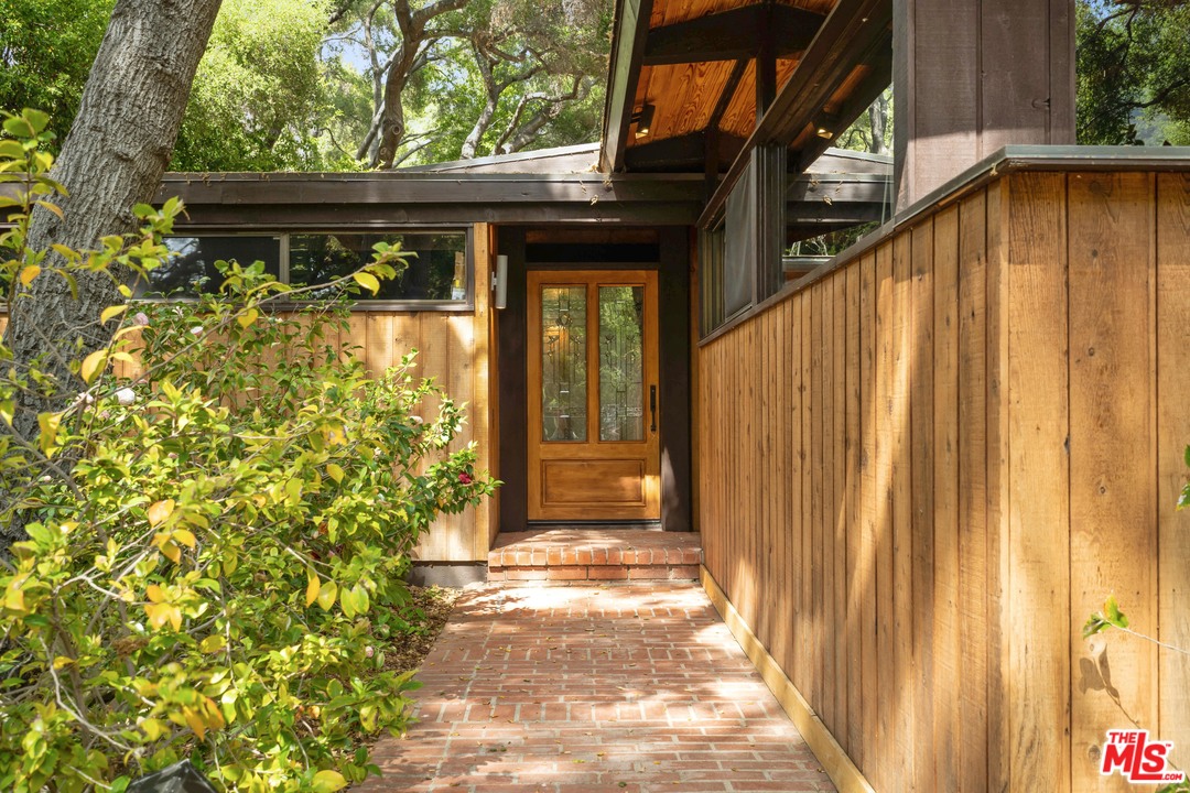 481 Cold Canyon Road Calabasas, CA 91302 - Photo 8 of 44 a view of a house with a wooden door
