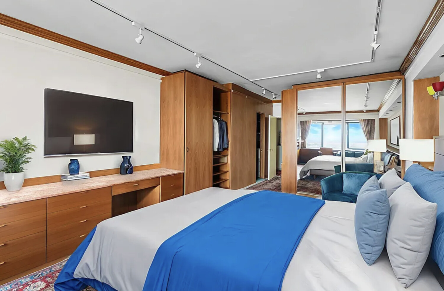 60 East End Avenue, Unit 27B Manhattan, NY 10028 - Photo 6 of 11 a bedroom with a bed and glass windows