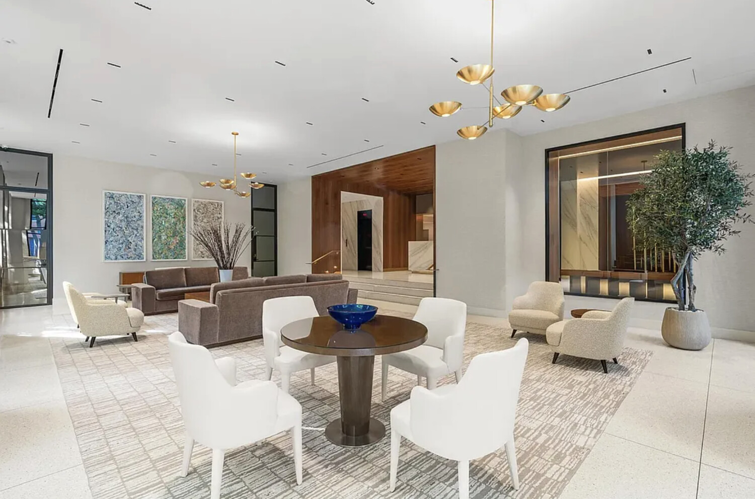 60 East End Avenue, Unit 27B Manhattan, NY 10028 - Photo 8 of 11 a living room with fireplace furniture and a chandelier