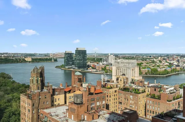 a living room with fireplace furniture and a chandelier