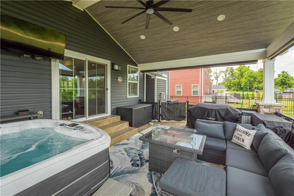 254 Regency Drive Eighty Four, PA 15330 - Photo 40 of 44 Patio includes privacy blinds surrounding the covered portion, offering shade, comfort, and enhanced privacy while enjoying the outdoor space or relaxing in the hot tub.