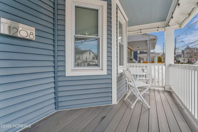 a view of a balcony with chairs and wooden floor