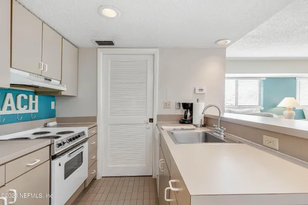 a kitchen that has a sink and a stove