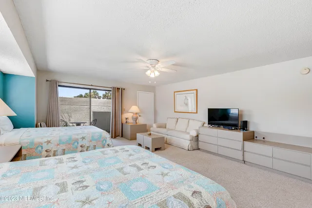 a bedroom with a large bed and a flat screen tv