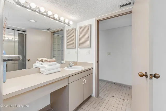 a bathroom with a sink a mirror and a shower