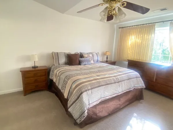 a bedroom with a bed and window