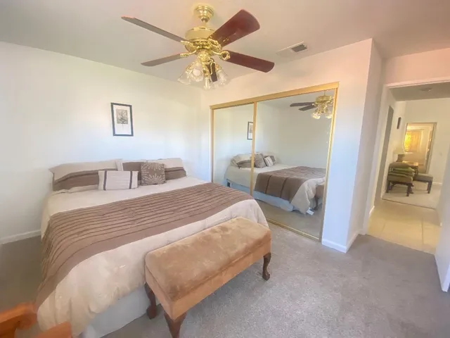 a bedroom with bed and a chandelier