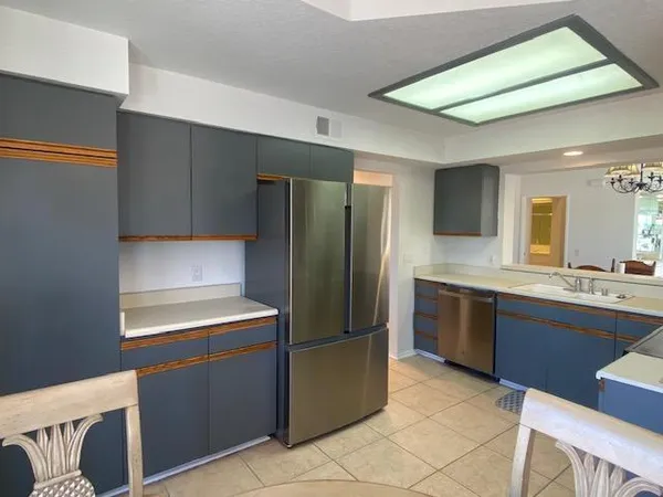 a kitchen with stainless steel appliances granite countertop a refrigerator and a stove