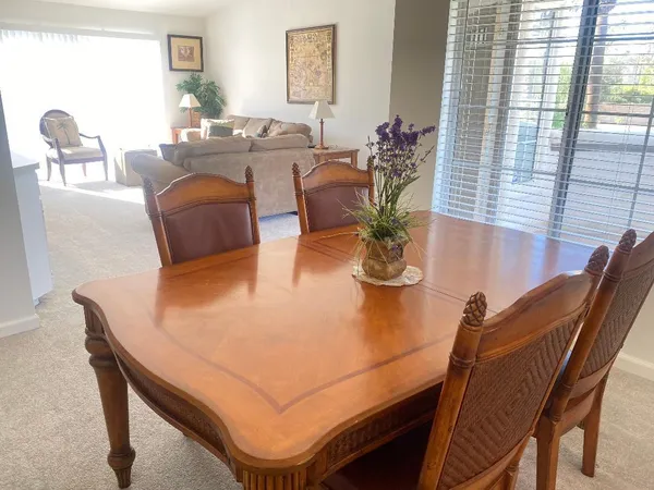 a dining room with furniture and wooden floor