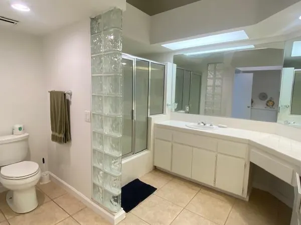a spacious bathroom with a sink toilet and shower