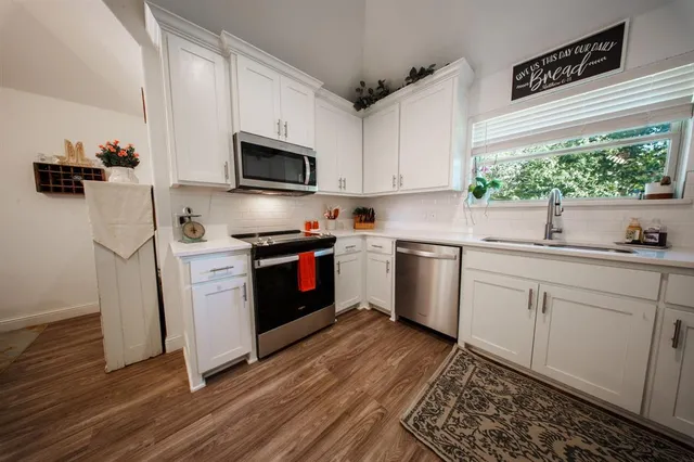 a kitchen with a sink cabinets and stainless steel appliances