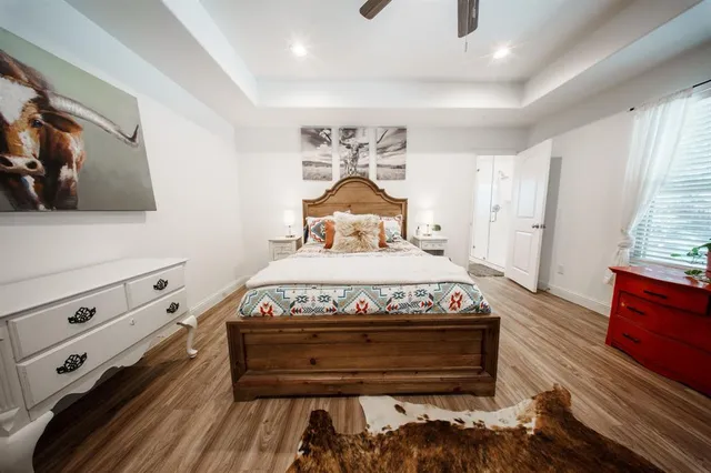 a bed sitting in a bedroom next to a window