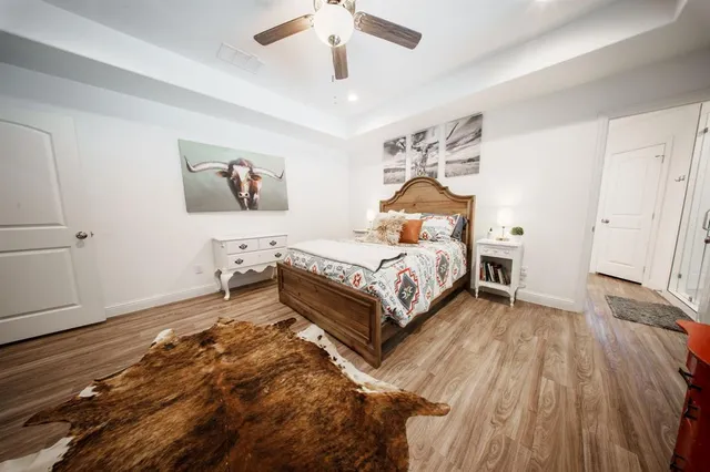 a bedroom with a bed and a chandelier