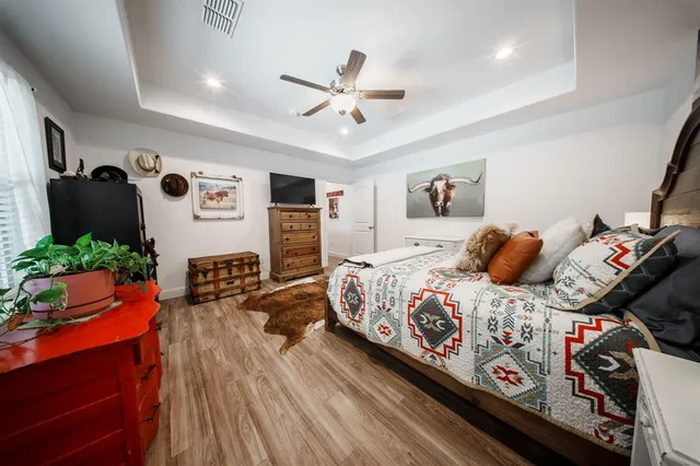 a bedroom with a bed and wooden floor