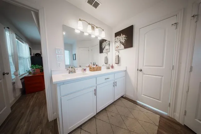 a spacious bathroom with a mirror sink and vanity