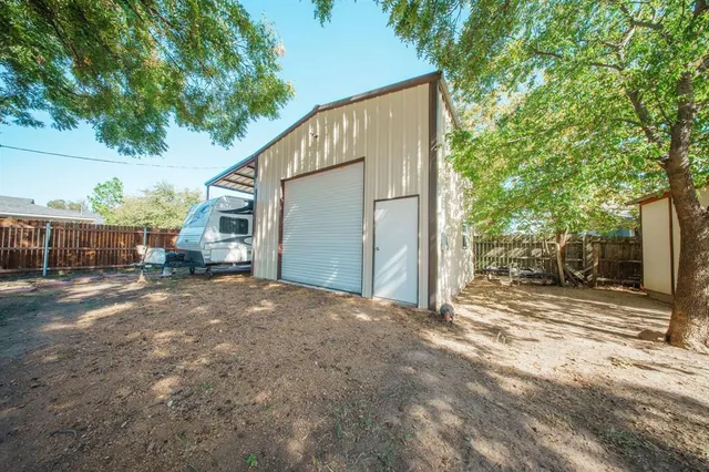 a view of a house with a yard and tree