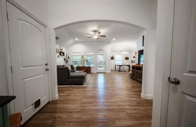a living room with furniture and a wooden floor
