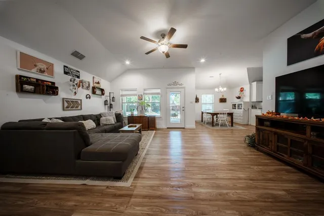 a living room with furniture and a flat screen tv