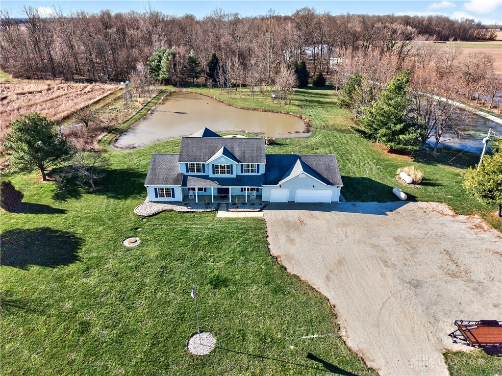 6560 Snyder Road Fletcher, OH 45326 - Photo 6 of 71 This charming residence offers serene lakeside living with spacious green surroundings and ample parking.