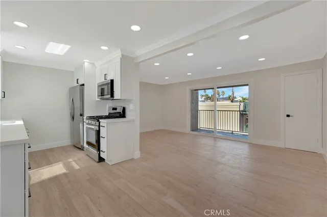 a view of kitchen with cabinets and wooden floor