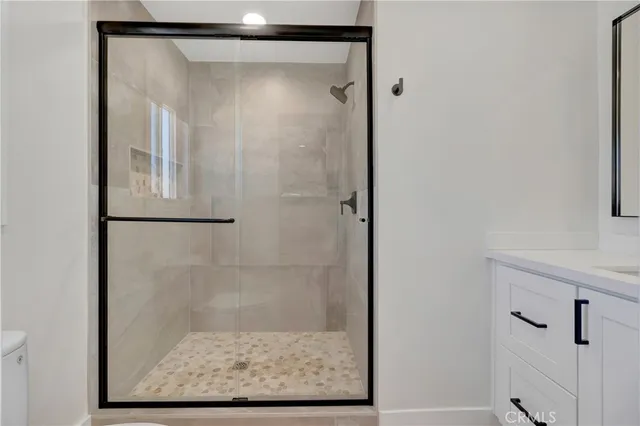 a bathroom with a shower and a sink