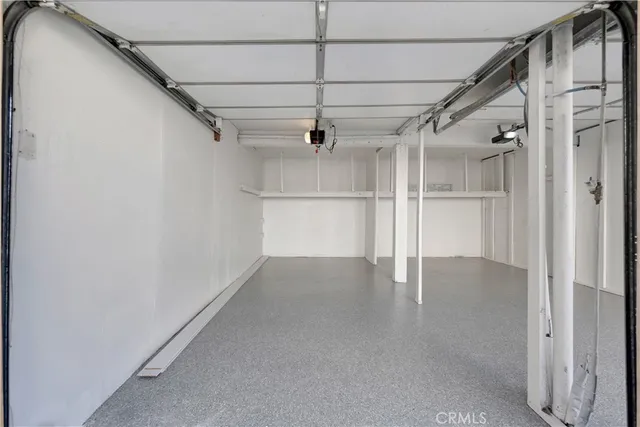 a view of a livingroom with wooden floor and a ceiling fan