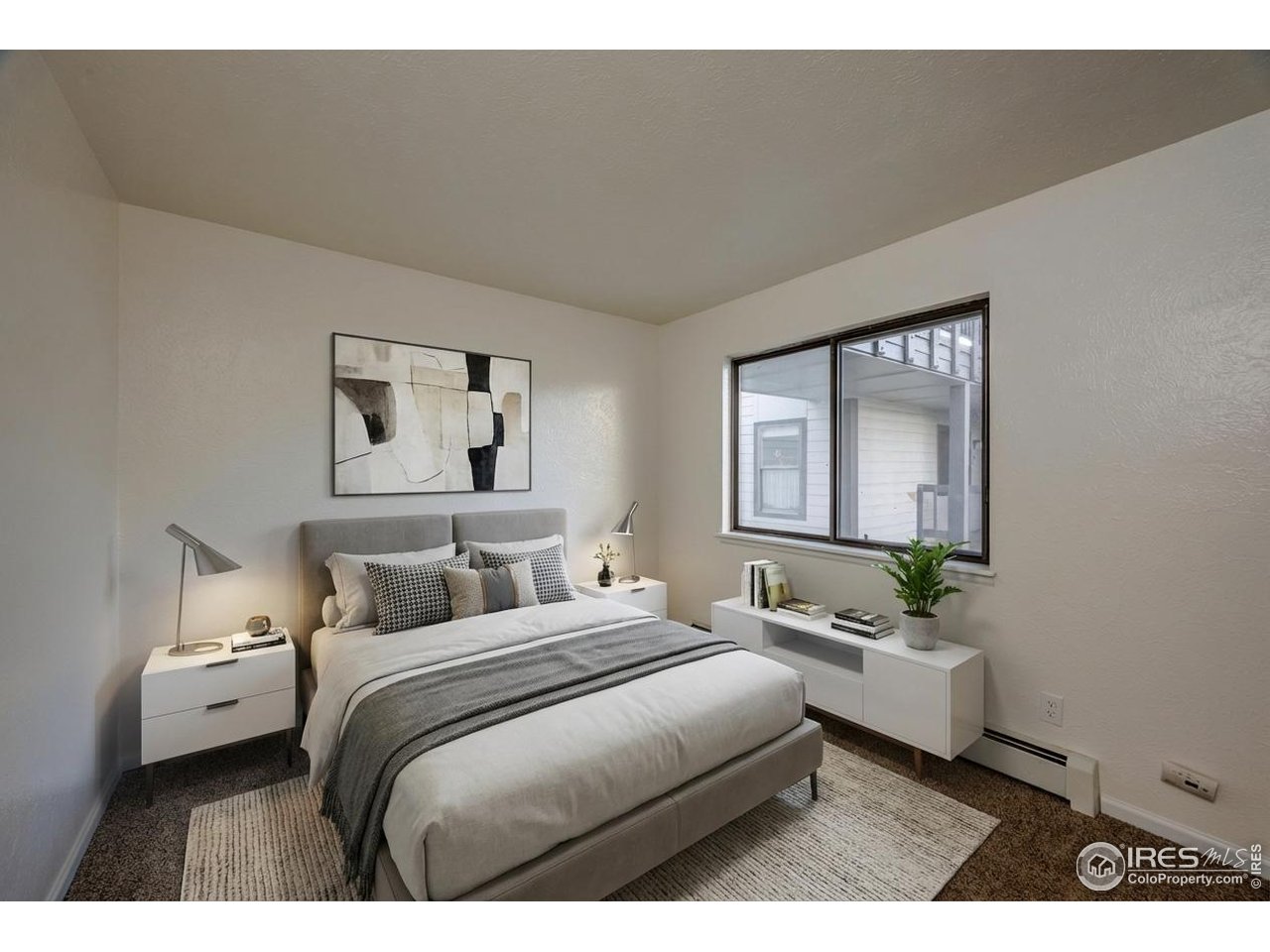 3295 34th Street, Unit 68 Boulder, CO 80301 - Photo 12 of 27 a bedroom with a bed a mirror and a window