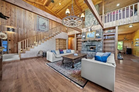 a living room with fireplace furniture and a wooden floor