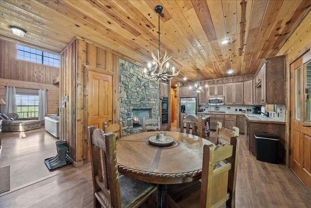 a dining room with kitchen island a table and chairs
