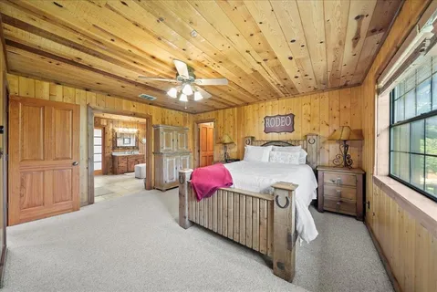 a bed room with a bed and large window