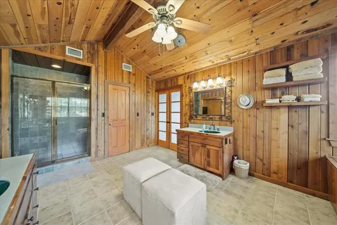 a large spacious bathroom with a granite countertop sink mirror and shower