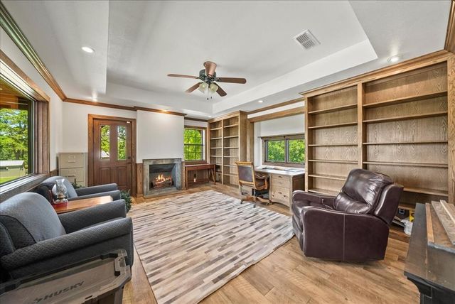 a living room with furniture ceiling fan and a window