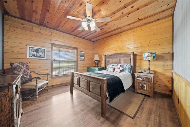 a bed room with a bed and a chair