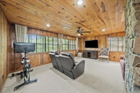 a living room with furniture a flat screen tv and a large window