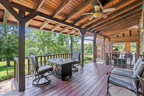 a view of a patio with wooden floor chairs and table