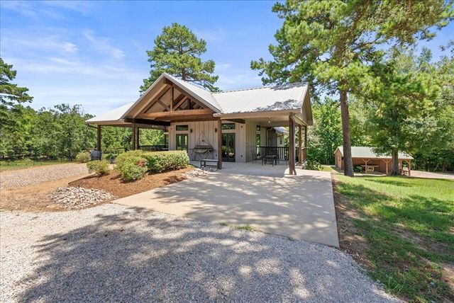 a front view of a house with a yard and a garage