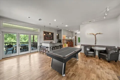 a living room with furniture a large window with wooden floor