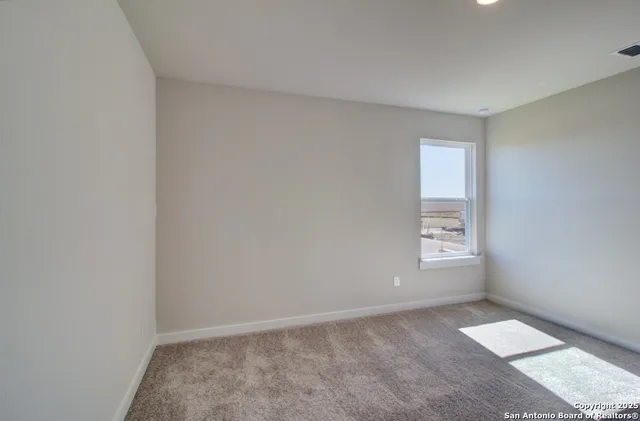 a view of an empty room and closet area