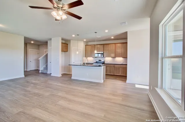 a view of a kitchen with a sink and a window