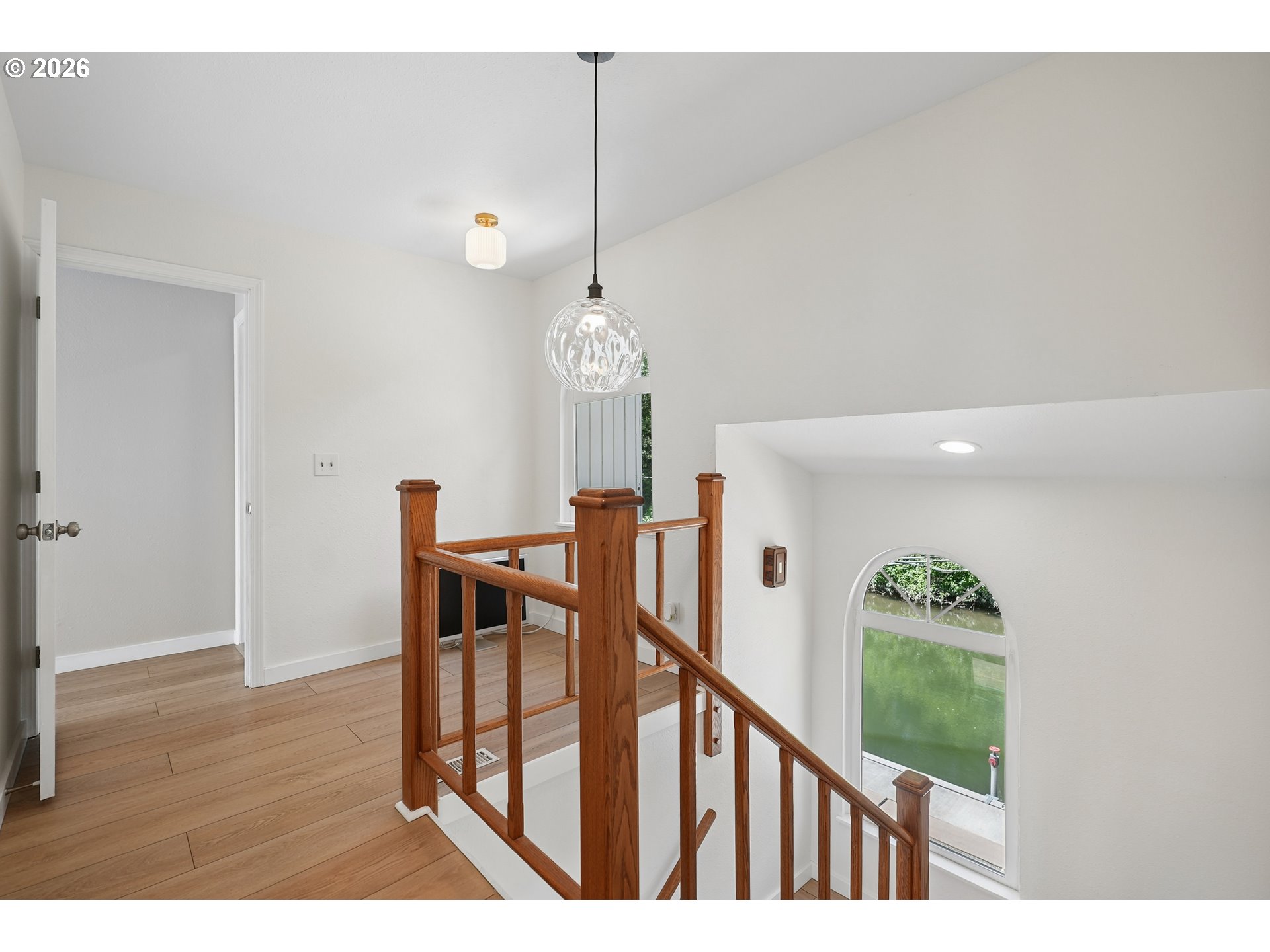 14936 Northwest Mill Road, Unit K Portland, OR 97231 - Photo 14 of 33 a view of a hallway with wooden floor and stairs