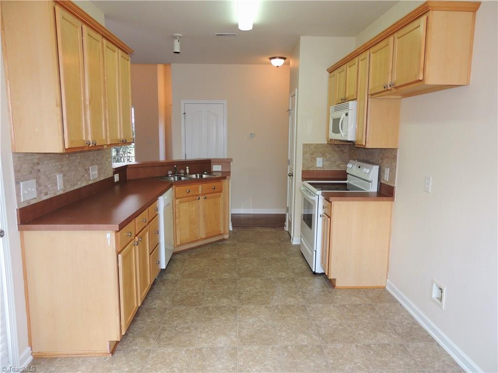 2124 Burton Run Road High Point, NC 27262 - Photo 11 of 29 Nice cabinetry, lots of counter space, and beautiful tile backsplash complete this kitchen!