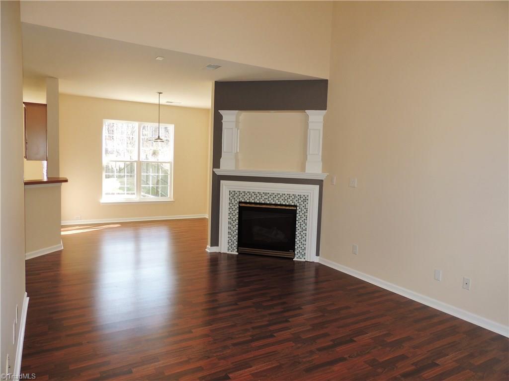 2124 Burton Run Road High Point, NC 27262 - Photo 7 of 29 Living room features a beautiful gas-log fireplace with tile surround! Living room is open to the kitchen and dining rooms!