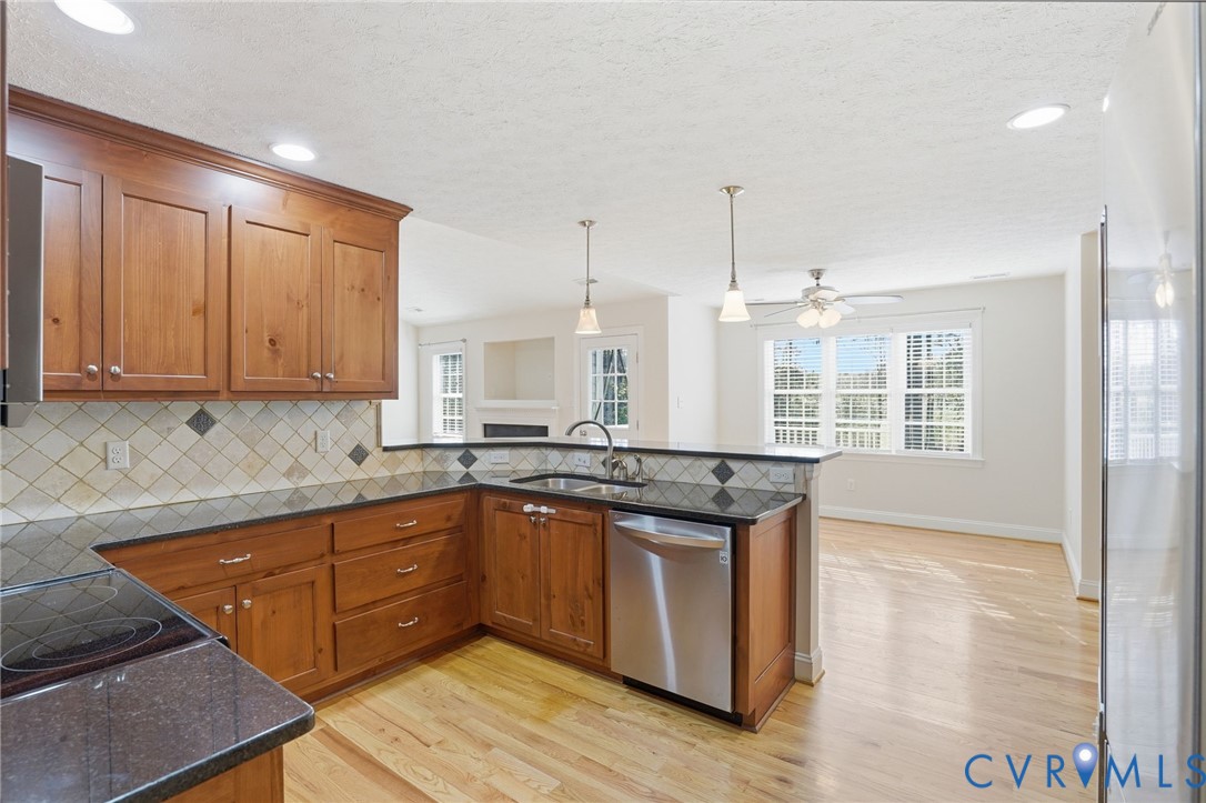 10326 Gould Hill Road Hanover, VA 23069 - Photo 13 of 43 a kitchen with stainless steel appliances granite countertop a sink a stove and a wooden floors