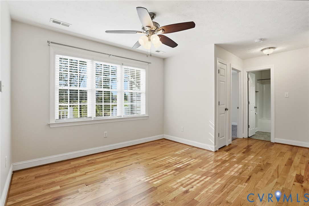 10326 Gould Hill Road Hanover, VA 23069 - Photo 15 of 43 a view of an empty room with wooden floor and a window